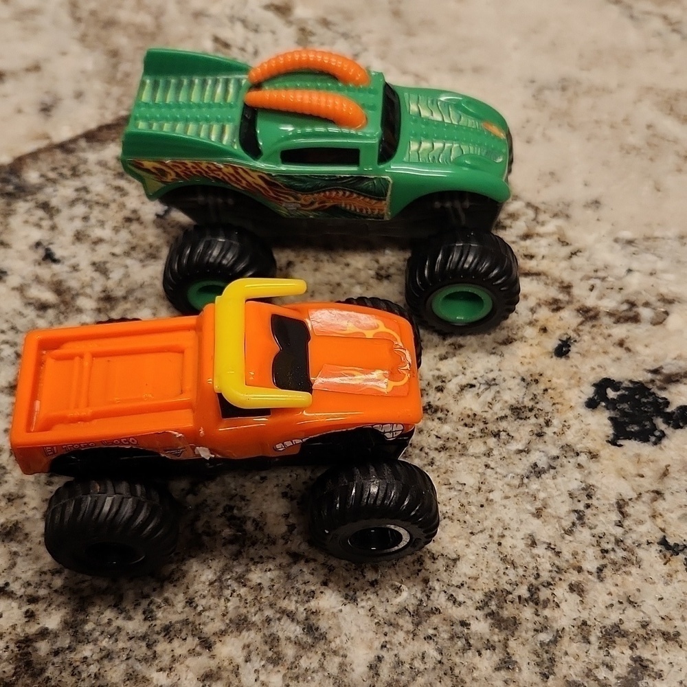 Monster jam plastic Rev up trucks has paper stickers ripping 2 cars